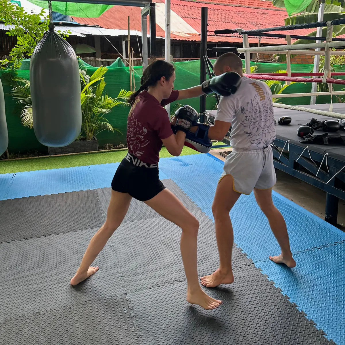 Two students practising coached pad work at The Temple.