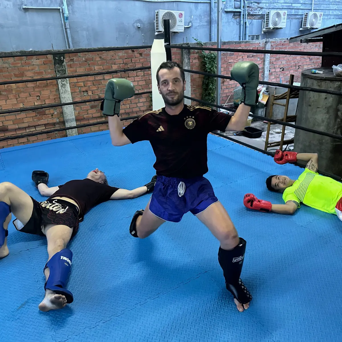 Kevin standing victorious in the ring after a fight.