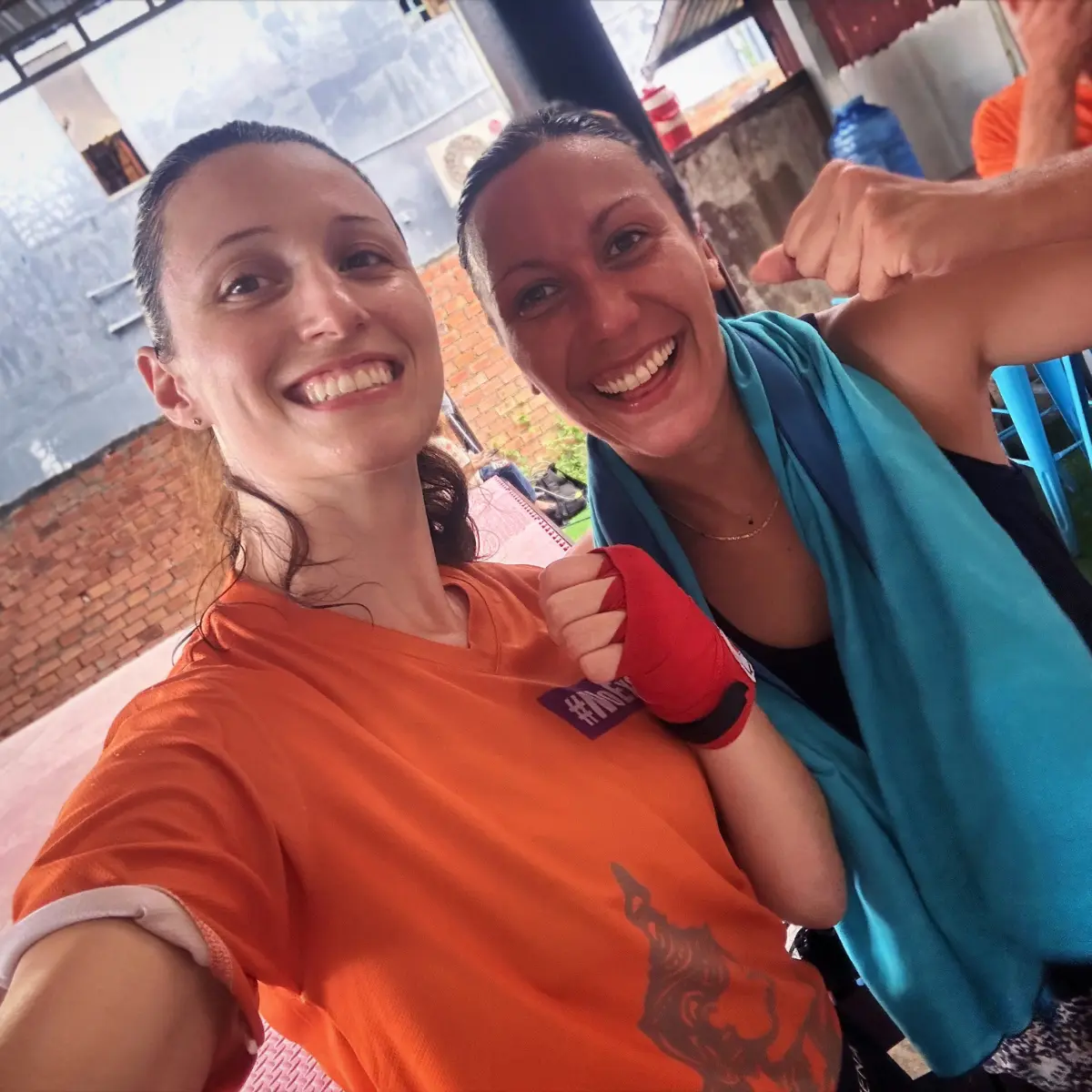 Dani taking a selfie with a training partner in gym wear.