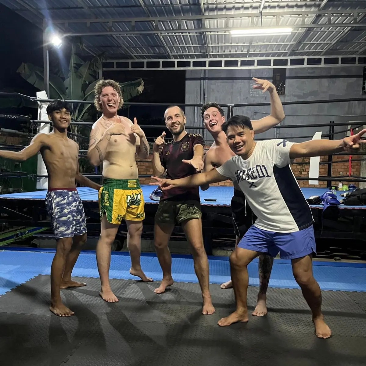 Albert and four training partners posing together by the boxing ring.